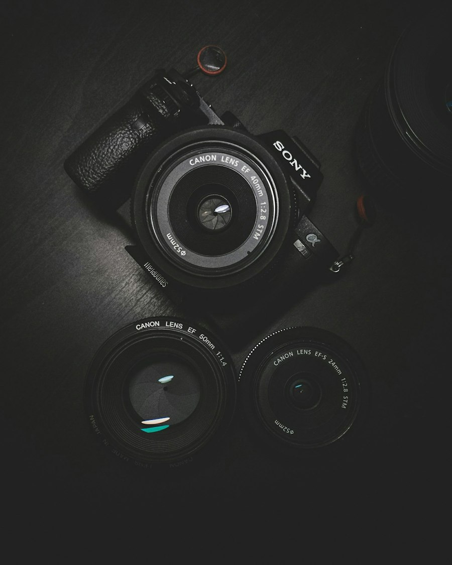Camera body and lenses laid out on a dark table