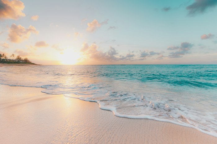 Golden sunset light over a quiet beach